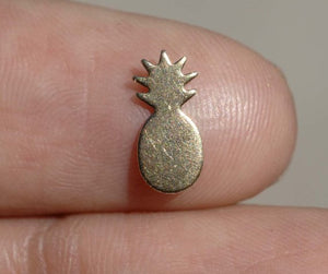 tiny bronze pineapple on a finger
